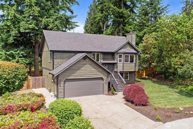 236 S 316th Pl, Federal Way, WA 98003 - raised ranch featuring concrete driveway, a chimney, a shingled roof, and a garage