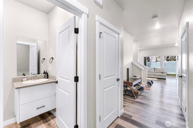2912 Sandwood Ln, Blaine, WA 98230 - corridor with a sink, wood finished floors, and baseboards