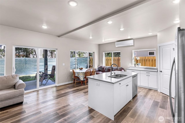 2912 Sandwood Ln, Blaine, WA 98230 - kitchen with open floor plan, an AC wall unit, stainless steel appliances, a sink, and recessed lighting