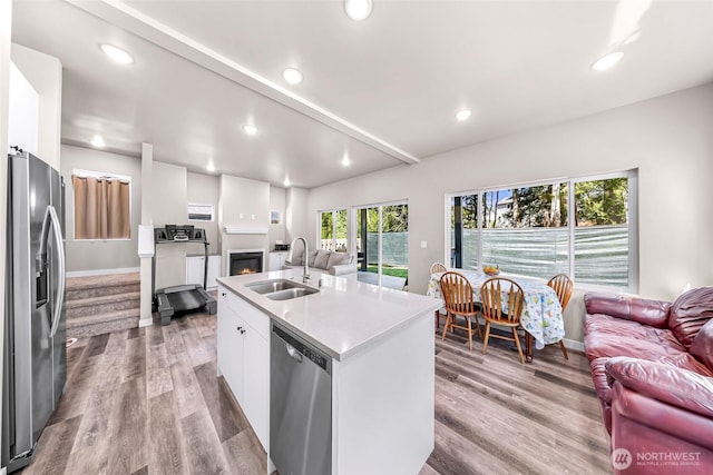 2912 Sandwood Ln, Blaine, WA 98230 - kitchen featuring open floor plan, a sink, appliances with stainless steel finishes, white cabinets, and baseboards