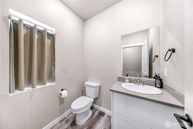 2912 Sandwood Ln, Blaine, WA 98230 - bathroom featuring toilet, vanity, wood finished floors, and baseboards