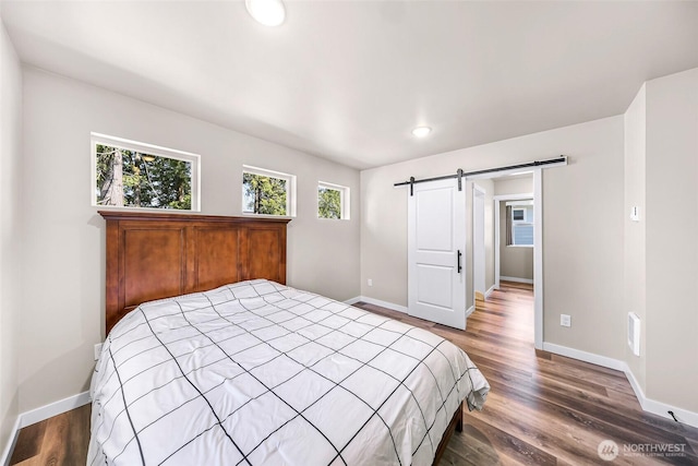 2912 Sandwood Ln, Blaine, WA 98230 - bedroom featuring a barn door, baseboards, wood finished floors, and recessed lighting