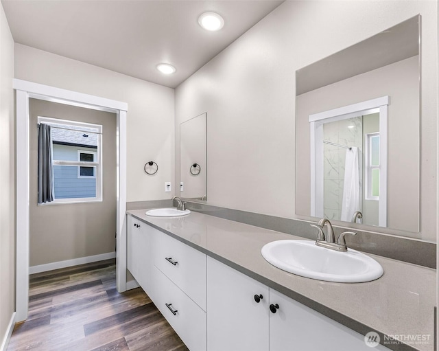 2912 Sandwood Ln, Blaine, WA 98230 - bathroom with double vanity, wood finished floors, recessed lighting, and baseboards