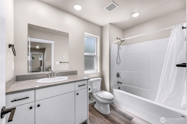 2912 Sandwood Ln, Blaine, WA 98230 - bathroom featuring toilet, shower / bath combo with shower curtain, vanity, and wood finished floors