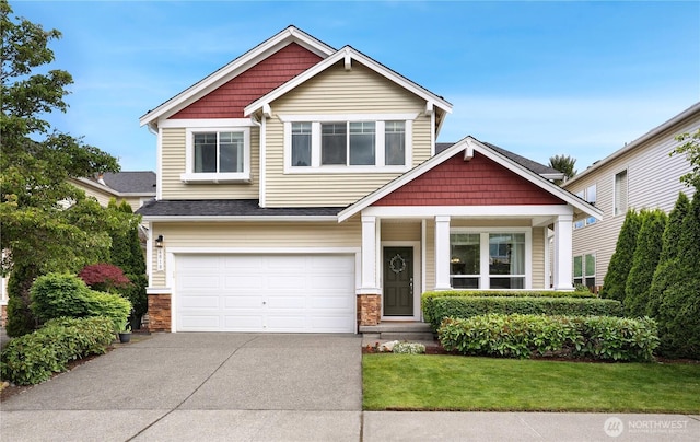 4810 S 215th St Unit 119, Kent, WA 98032 - craftsman house featuring concrete driveway, an attached garage, a front lawn, covered porch, and stone siding