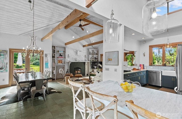 26742 94th Ave SW, Vashon, WA 98070 - kitchen with stainless steel dishwasher, light countertops, high vaulted ceiling, a premium fireplace, and beamed ceiling