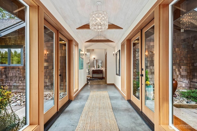 26742 94th Ave SW, Vashon, WA 98070 - hall featuring lofted ceiling, finished concrete floors, a chandelier, wooden ceiling, and plenty of natural light