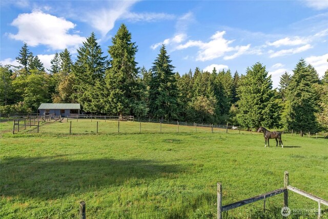 26742 94th Ave SW, Vashon, WA 98070 - view of yard with a view of rural / pastoral area, an outdoor structure, a wooded view, and an exterior structure