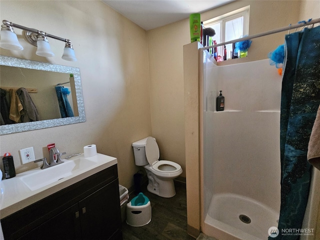 947 19th Ave, Longview, WA 98632 - full bathroom featuring vanity, a stall shower, toilet, and wood finished floors