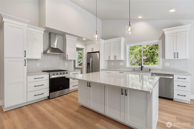 19 Inglewood Pl, Bellingham, WA 98229 - kitchen with wall chimney exhaust hood, appliances with stainless steel finishes, a sink, light countertops, and high vaulted ceiling