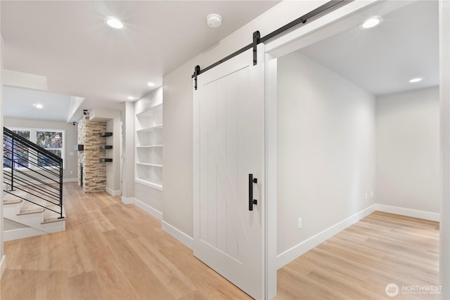 19 Inglewood Pl, Bellingham, WA 98229 - hall with a barn door, light wood-style flooring, baseboards, recessed lighting, and stairs