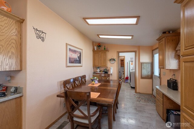 307 Hilltop Cir, Ephrata, WA 98823 - dining area with lofted ceiling, light flooring, and baseboards