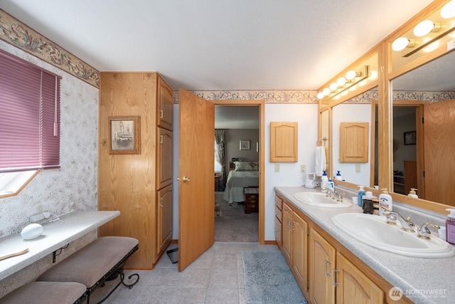307 Hilltop Cir, Ephrata, WA 98823 - ensuite bathroom featuring double vanity, wallpapered walls, and tile patterned flooring