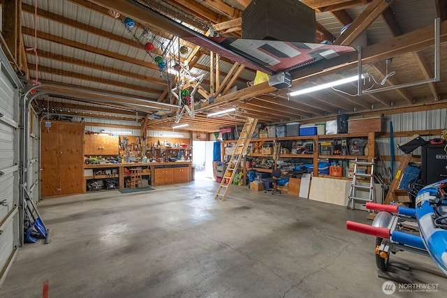 307 Hilltop Cir, Ephrata, WA 98823 - garage with a workshop area and a garage door opener