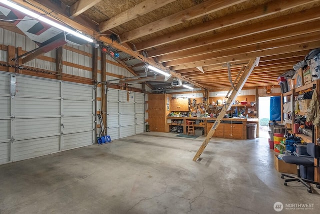 307 Hilltop Cir, Ephrata, WA 98823 - garage with a workshop area and a garage door opener