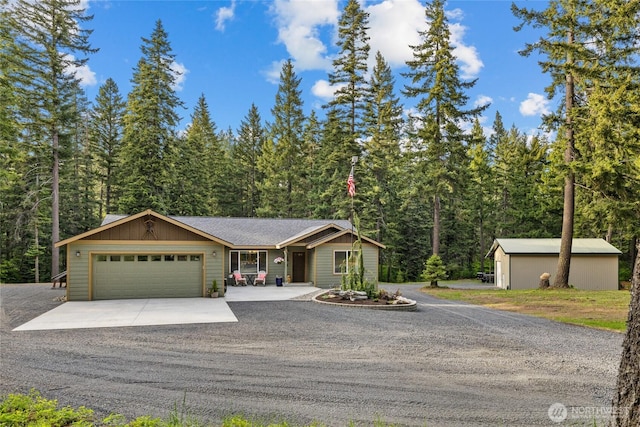 1091 Big Horn Way, Cle Elum, WA 98922 - view of front of property with concrete driveway, a garage, and a forest view