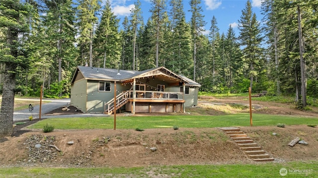 1091 Big Horn Way, Cle Elum, WA 98922 - view of front facade featuring stairway, a forest view, a deck, and a front lawn