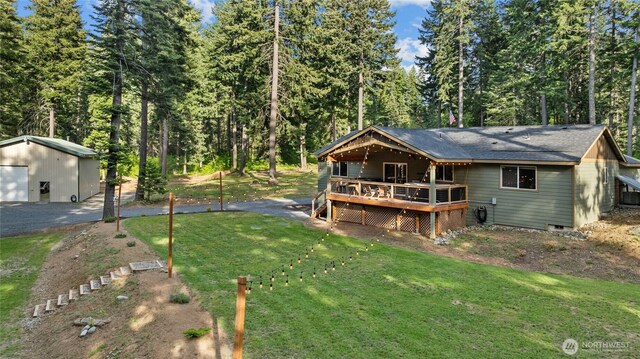 1091 Big Horn Way, Cle Elum, WA 98922 - back of property with a wooden deck, a yard, a detached garage, and central AC unit