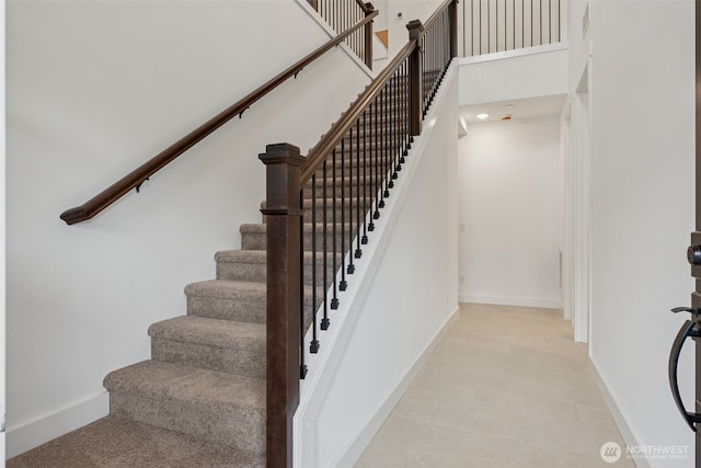 15706 210th Ave E Unit 312, Bonney Lake, WA 98391 - staircase with baseboards and a high ceiling