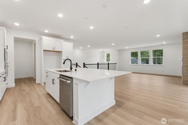 15706 210th Ave E Unit 312, Bonney Lake, WA 98391 - kitchen featuring stainless steel appliances, a sink, light wood-style floors, an island with sink, and white cabinets