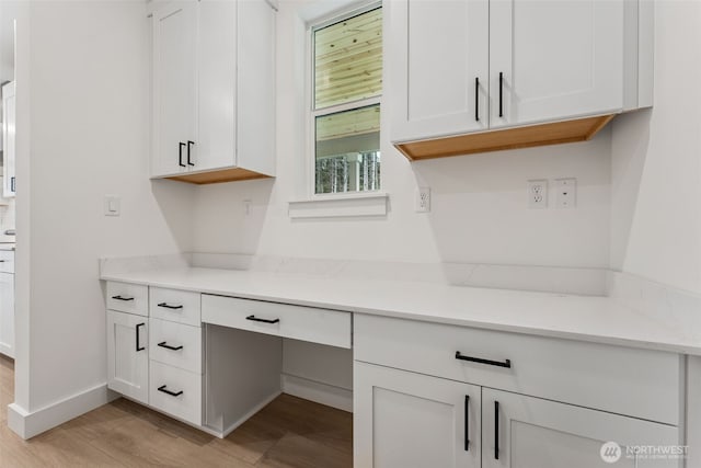 15706 210th Ave E Unit 312, Bonney Lake, WA 98391 - kitchen featuring light wood-style floors, white cabinetry, and light countertops