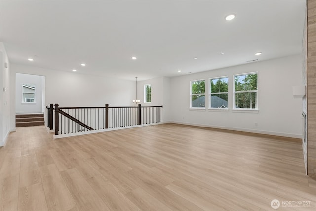 15706 210th Ave E Unit 312, Bonney Lake, WA 98391 - unfurnished room with a chandelier, light wood-style floors, recessed lighting, and baseboards