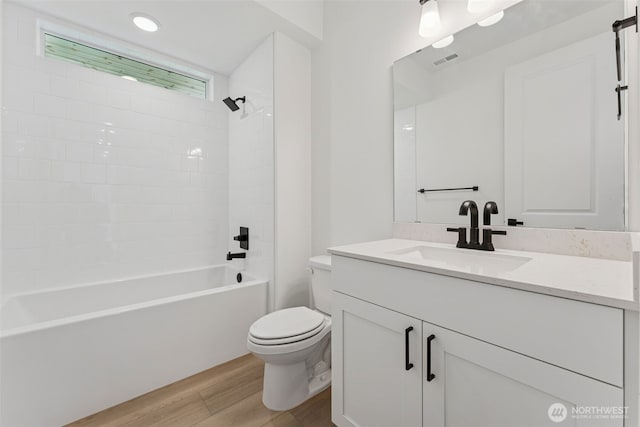 15706 210th Ave E Unit 312, Bonney Lake, WA 98391 - bathroom featuring wood finished floors, toilet, vanity, and  shower combination