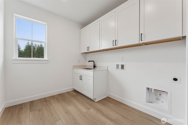 15706 210th Ave E Unit 312, Bonney Lake, WA 98391 - laundry room with hookup for a washing machine, cabinet space, hookup for an electric dryer, light wood-type flooring, and baseboards