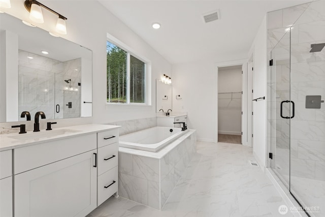 15706 210th Ave E Unit 312, Bonney Lake, WA 98391 - bathroom featuring marble finish floors, a bath, vanity, a marble finish shower, and a spacious closet