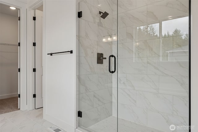 15706 210th Ave E Unit 312, Bonney Lake, WA 98391 - full bath featuring a marble finish shower, baseboards, marble finish flooring, and a walk in closet