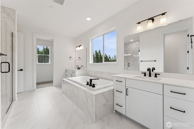 15706 210th Ave E Unit 312, Bonney Lake, WA 98391 - bathroom featuring a shower stall, a bath, two vanities, and recessed lighting