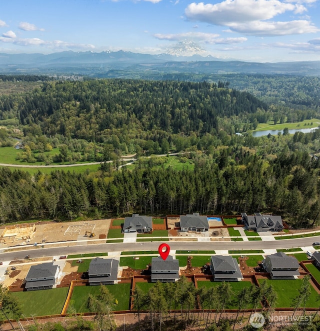 15706 210th Ave E Unit 312, Bonney Lake, WA 98391 - drone / aerial view of a heavily wooded area and a water and mountain view