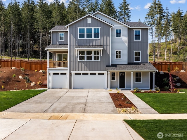 15706 210th Ave E Unit 312, Bonney Lake, WA 98391 - view of front facade featuring board and batten siding, covered porch, a garage, concrete driveway, and a shingled roof