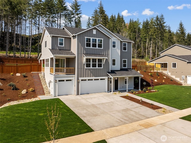 15706 210th Ave E Unit 312, Bonney Lake, WA 98391 - view of front of house with stairs, board and batten siding, a garage, and concrete driveway