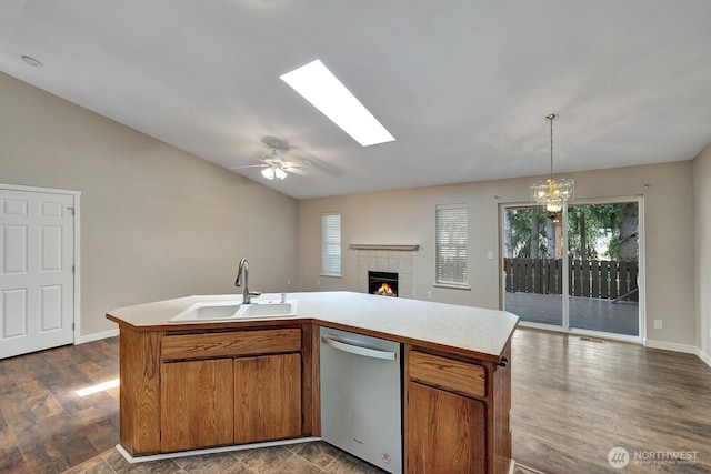 8115 109th St E Unit 8117, Puyallup, WA 98373 - kitchen with dishwasher, a sink, open floor plan, light countertops, and a tile fireplace