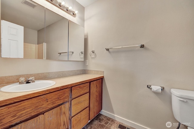8115 109th St E Unit 8117, Puyallup, WA 98373 - bathroom with vanity, toilet, baseboards, and tile patterned floors