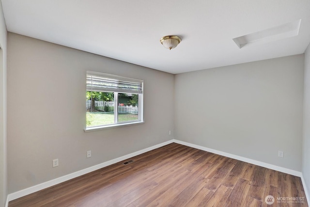 8115 109th St E Unit 8117, Puyallup, WA 98373 - unfurnished room with attic access, baseboards, and wood finished floors