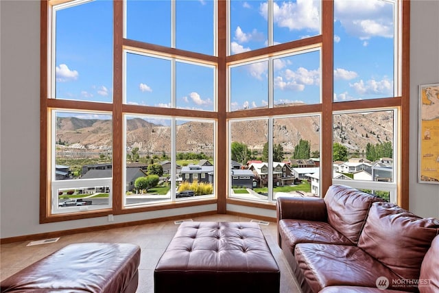 340 W Beach Dr, Orondo, WA 98843 - tiled living area featuring a mountain view, a towering ceiling, and baseboards