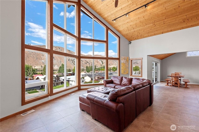 340 W Beach Dr, Orondo, WA 98843 - tiled living area featuring high vaulted ceiling, track lighting, wood ceiling, baseboards, and a mountain view
