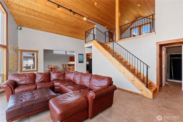 340 W Beach Dr, Orondo, WA 98843 - living area with track lighting, high vaulted ceiling, wooden ceiling, stairs, and baseboards