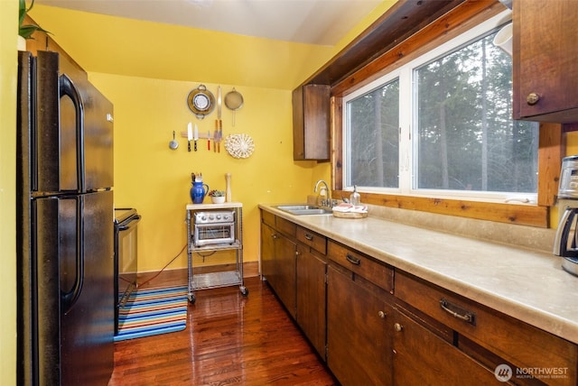 451 Aspen Springs Rd, Cle Elum, WA 98922 - kitchen with black appliances, a sink, dark wood finished floors, light countertops, and baseboards