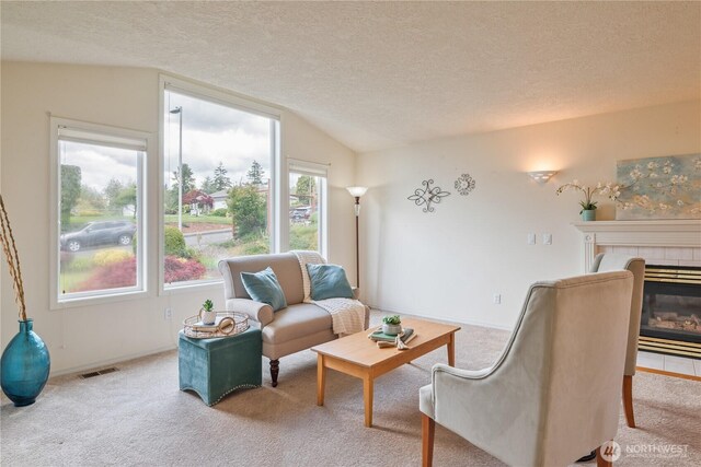 1426 Pries Ct, Kelso, WA 98626 - living room with carpet flooring, vaulted ceiling, a textured ceiling, a tiled fireplace, and baseboards