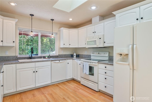 1426 Pries Ct, Kelso, WA 98626 - kitchen featuring white appliances, a sink, a skylight, white cabinetry, and pendant lighting