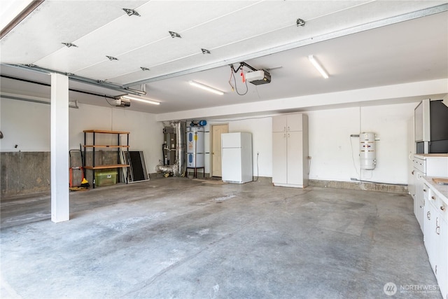 1426 Pries Ct, Kelso, WA 98626 - garage featuring freestanding refrigerator, secured water heater, a central vacuum unit, and a garage door opener
