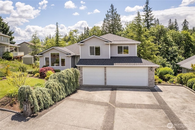 1426 Pries Ct, Kelso, WA 98626 - tri-level home with concrete driveway, a garage, roof with shingles, and brick siding