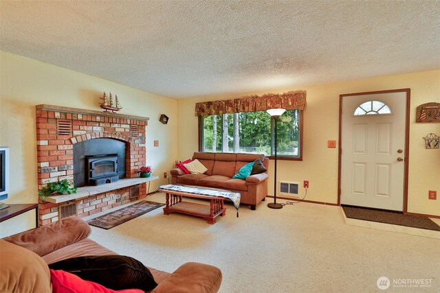 247 Bass Ave NE, Ocean Shores, WA 98569 - living room featuring carpet, a textured ceiling, a wood stove, and baseboards