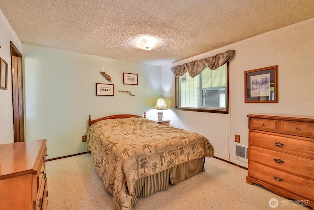 247 Bass Ave NE, Ocean Shores, WA 98569 - bedroom with a textured ceiling, light colored carpet, and baseboards