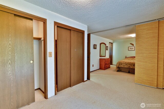247 Bass Ave NE, Ocean Shores, WA 98569 - carpeted bedroom with multiple closets and a textured ceiling