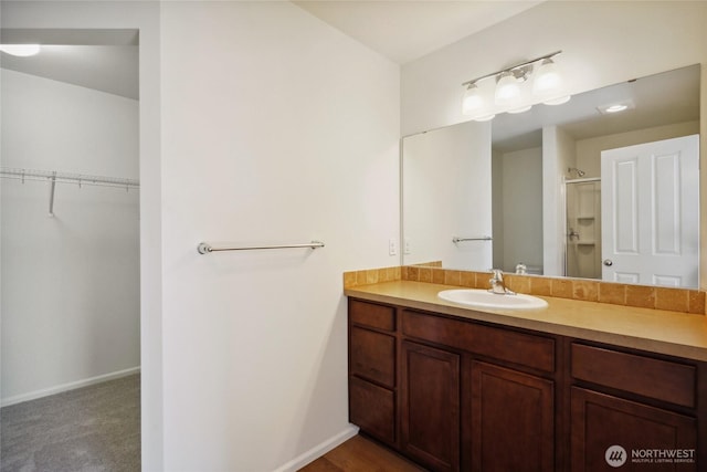 4825 E Q St Unit 2922, Tacoma, WA 98404 - full bathroom featuring a stall shower, vanity, a spacious closet, and baseboards