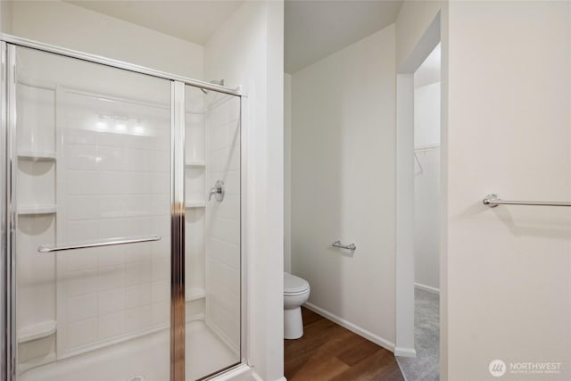 4825 E Q St Unit 2922, Tacoma, WA 98404 - bathroom featuring a shower stall, toilet, wood finished floors, a spacious closet, and baseboards
